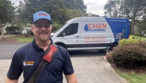 Chen Plumbing Technician Next To Parked Truck