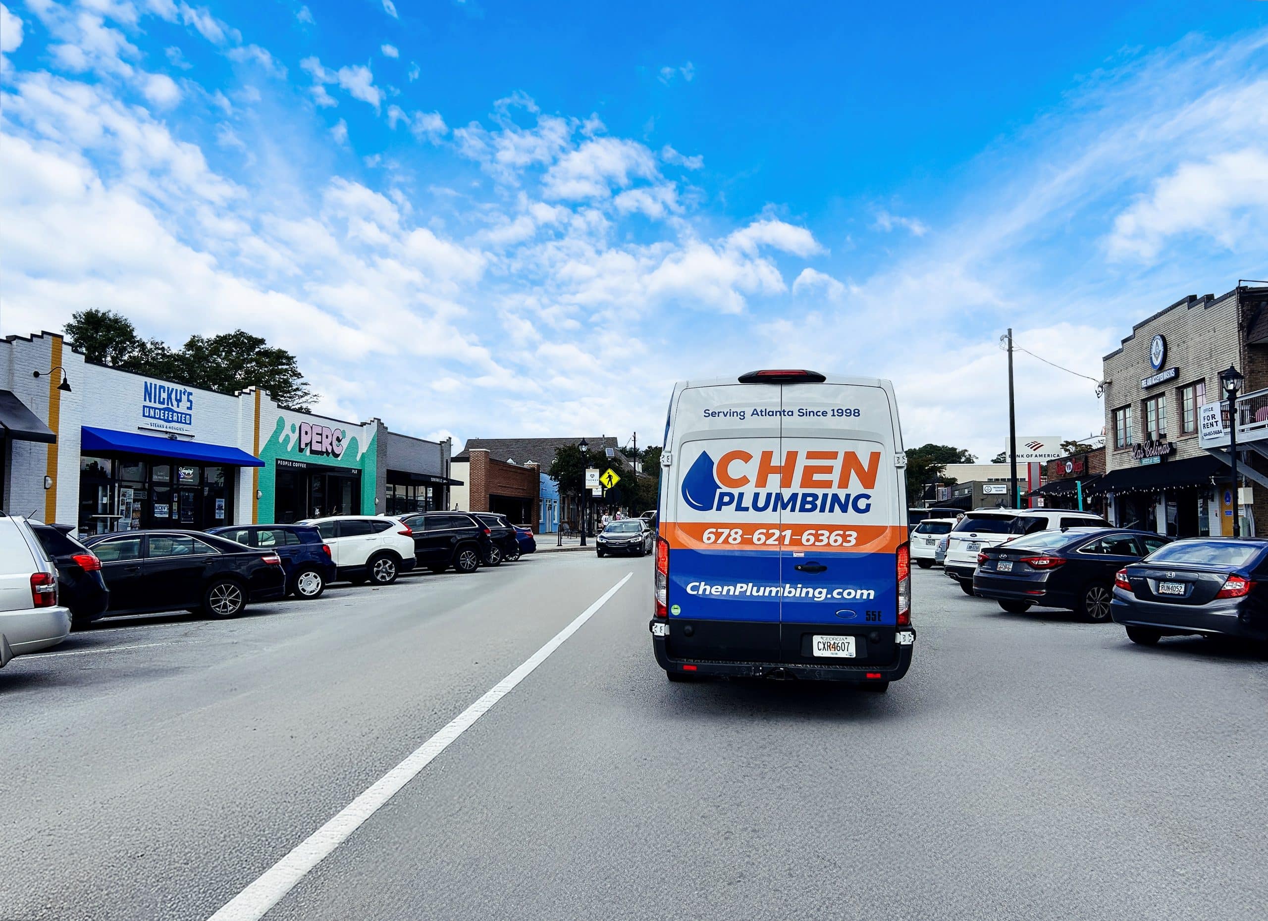 Tucker, GA – Chen Plumbing Van Chen Plumbing service van driving through downtown Tucker, GA, providing trusted plumbing services since 1998.