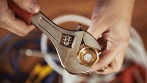 Plumber Using Wrench On Install