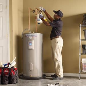 Licensed Atlanta plumber installing a new energy-efficient water heater for a residential homeowner.